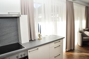 a kitchen with white cabinets and a stove top oven at Bergruh Steeg in Steeg