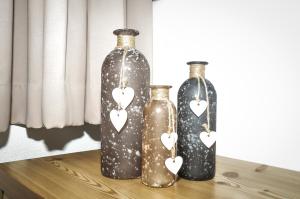 three bottles with hearts on them sitting on a table at Bergruh Steeg in Steeg