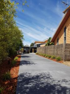 a car is parked on a driveway next to a house at Zeally Bay Stay Deep Ocean in Torquay