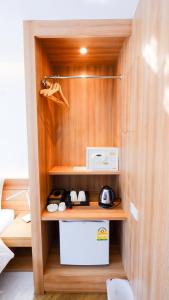 a room with a cupboard with a toaster and aether at Pinnacle Dream in Bangkok