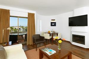 a living room with a couch and a table at Sao Rafael Holidays in Albufeira