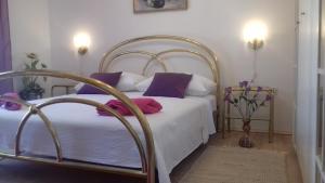 a bedroom with a white bed with purple pillows at Villa Blue View in Sumpetar