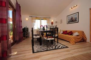 a living room with a bed and a table and chairs at Villa Blue View in Sumpetar