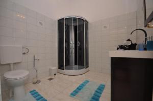 a bathroom with a shower and a toilet in it at Villa Blue View in Sumpetar +130 photos