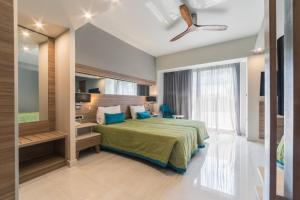 a bedroom with a bed and a large window at Atrion Resort Hotel in Agia Marina Nea Kydonias