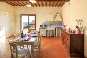 a kitchen with a table and chairs in a room at Agriturismo Streda Wine & Country Holiday in Vinci