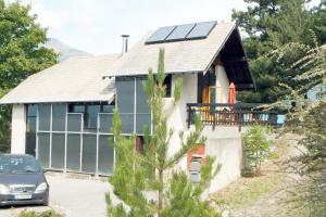a house with solar panels on the roof at Maison CAILLE in Embrun