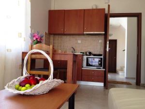 a kitchen with a basket of fruit on a table at Nice & Quiet Apartment in Best Area in Alexandroupoli