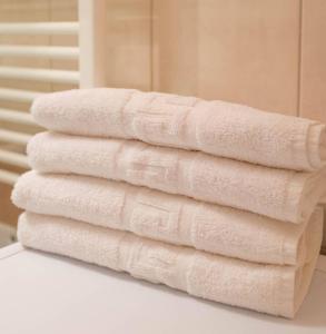 a stack of towels sitting on a counter in a bathroom at Nice & Quiet Apartment in Best Area in Alexandroupoli