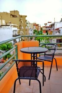 a table and two chairs sitting on a balcony at Nice & Quiet Apartment in Best Area in Alexandroupoli