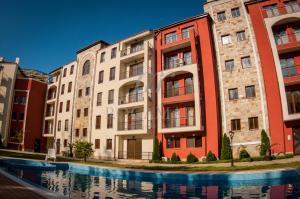 a group of buildings next to a swimming pool at Menada Rocamar Apartments in Tsarevo