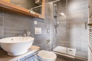 a bathroom with a sink and a toilet and a shower at Hotel Björnson Jasná & Björnson TREE HOUSES in Belá