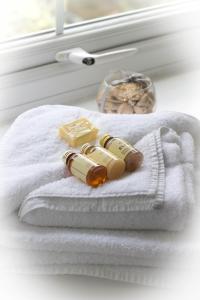 two bottles of soap sitting on a towel next to a window at The Elks Head Inn in Whitfield