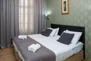 Postel nebo postele na pokoji v ubytování Hotel Arc Tbilisi