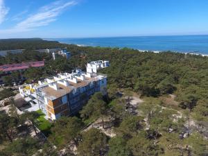 an aerial view of a building on a hill next to the ocean at Apartament Piaskowy NR A5 (3-5 os.) in Rowy