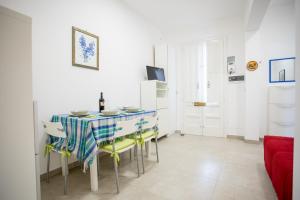 a dining room with a table and chairs at Sunset Holiday House in Torre Lapillo