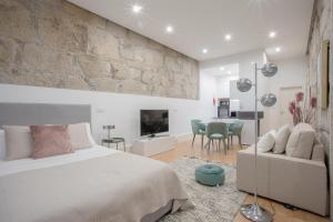 a bedroom with a bed and a living room at Liiiving In Porto | Downtown Luxury Apartments in Porto