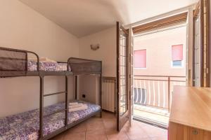 a room with two bunk beds and a balcony at Biroli164 House in Ciampino