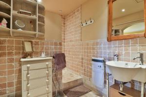 a bathroom with a sink and a toilet at Les Carmes and spa in Le Thor