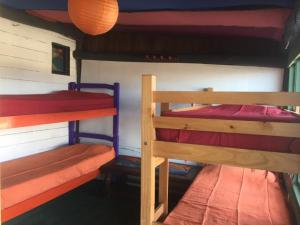 a room with two bunk beds in a house at La Cañada Cabo Polonio in Cabo Polonio