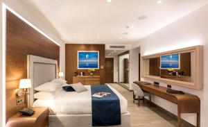 A bed or beds in a room at Nana Princess Suites Villas & Spa
