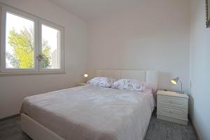 Postel nebo postele na pokoji v ubytování Apartman Topolino