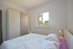 Postel nebo postele na pokoji v ubytování Apartman Topolino