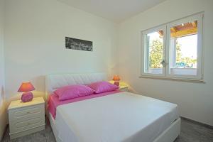 Postel nebo postele na pokoji v ubytování Apartman Topolino
