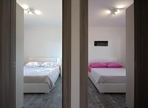 Postel nebo postele na pokoji v ubytování Apartman Topolino