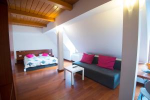 a living room with a couch and a bed at Pensjonat Maria 2 in Szczyrk