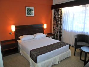 a hotel room with a bed and a window at Hotel Seri Malaysia Kangar in Kangar