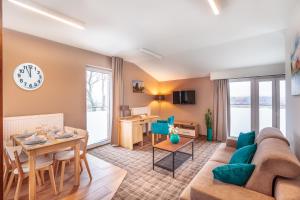 a living room with a couch and a table at SOLAVO HOME&TRAVEL in Solec-Zdrój