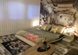 a bedroom with a large bed and a table at Lipno Pearl in Lipno nad Vltavou