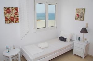 A bed or beds in a room at white house by the sea