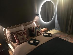 a bedroom with a bed with a large mirror at Cityapartment Graz in Graz