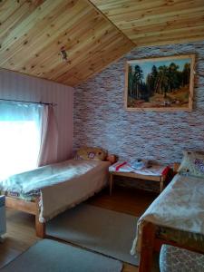 a bedroom with two beds and a brick wall at Sadyba Radisnyanka in Radisne