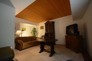 a living room with a couch and a television at Ferienhaus Familie Martens in Sittensen