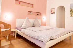 a bedroom with a bed and a chair at Apartment 1, Rothenburger Straße in Dresden