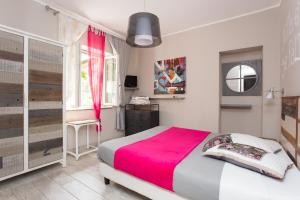 a bedroom with a large bed with a pink blanket at Villa Sea Rose in Lipari