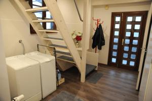 a laundry room with a staircase in a house at Maison La Rive in Publier