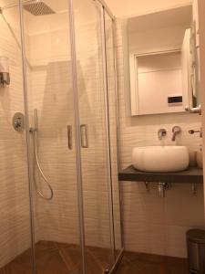 a bathroom with a sink and a shower at Pantheon Luxury Suite in Rome