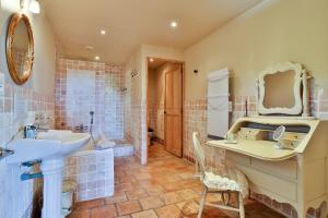 a bathroom with a sink and a mirror at Les Carmes and spa in Le Thor