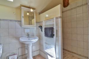a bathroom with a sink and a mirror at Les Carmes and spa in Le Thor