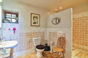 a bathroom with a toilet and a sink at Les Carmes and spa in Le Thor