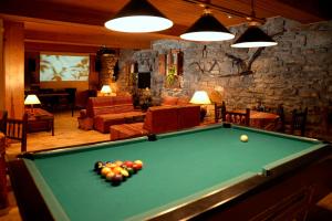 a living room with a pool table in a room at Hotel Pradas Ordesa in Broto