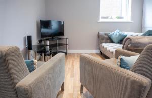 a living room with three couches and a tv at Bootham Retreat- Superb City Centre Hideaway-Free Parking in York