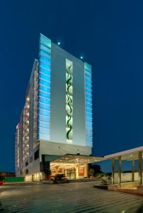 a large building with blue lights on top of it at Ramada Ahmedabad in Ahmedabad