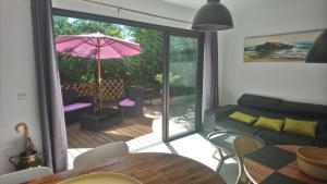a living room with a couch and an umbrella at Les Bambous in Petite Île