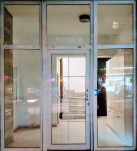 a glass door of a store with a sign on it at Standard Apartment by Prima Lodging in Thessaloniki