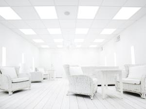 a room with white chairs and tables and a ceiling at Arken Hotel & Art Garden Spa in Gothenburg